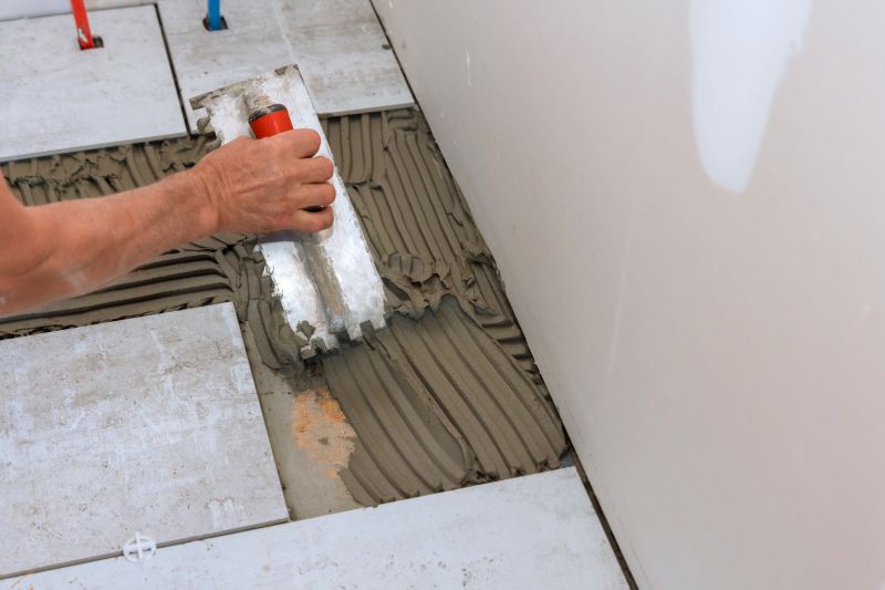 Expert tiler working on a bathroom